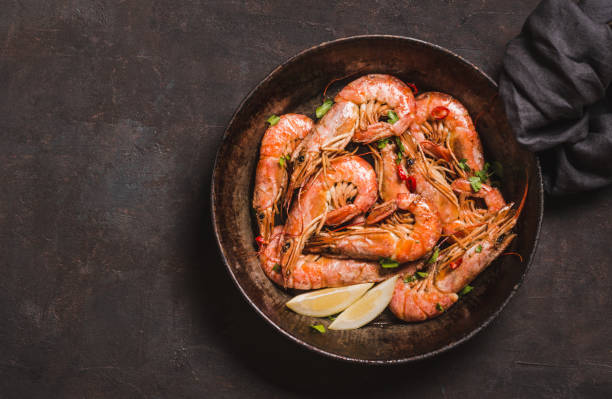 shrimps on dark background copy space. - grilled shrimp imagens e fotografias de stock