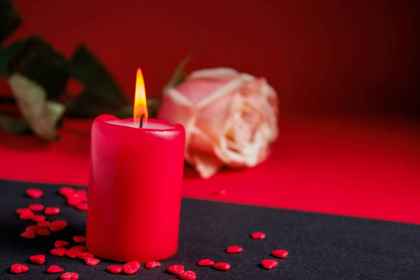 istock A burning red candle and a rose. Valentine's Day concept. 1367395774