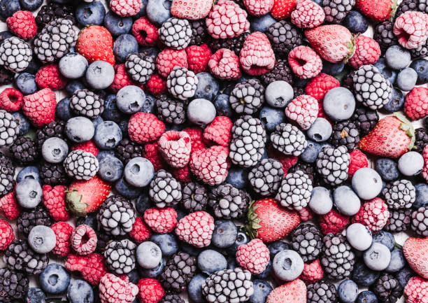 istock Frozen berries fruits background.Berries with frost. 1367395810