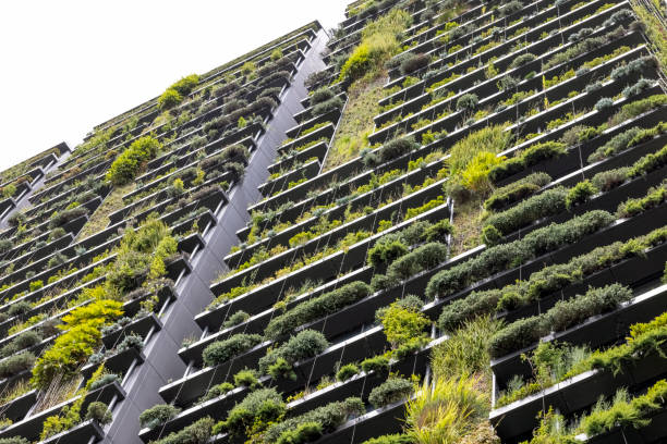 istock Low angle view of apartment building with vertical gardens, background with copy space 1367396088