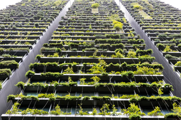 istock Low angle view of apartment building with vertical gardens, background with copy space 1367397317