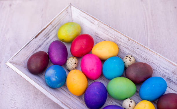 istock colorful Easter eggs on white wooden background 1367398296