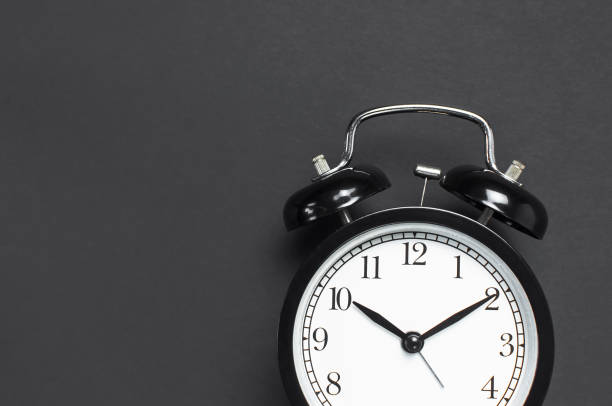 istock Black retro alarm clock on gray dark background top view Flat lay copy space. Minimalistic background, concept of time, deadline, time to work, morning 1367398673