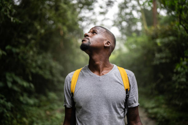 Young vitiligo man contemplating nature