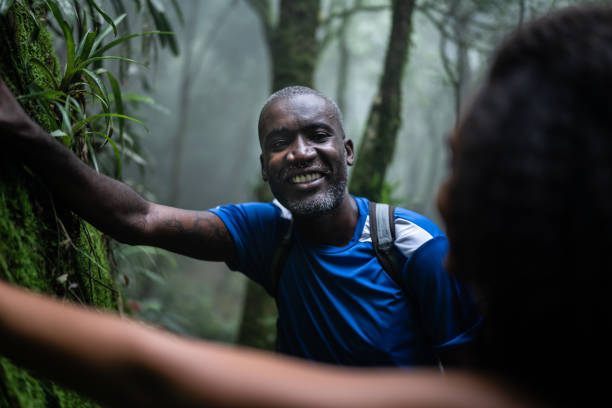 istock Mature man touching a tree in the forest 1367398726
