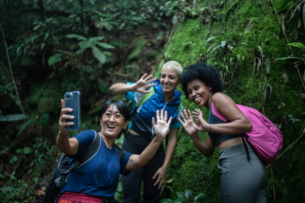 istock Friends on a video call on the mobile phone in the forest 1367398768