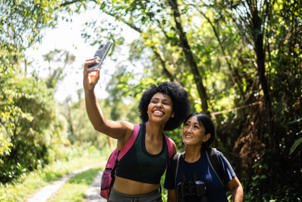 istock Friends taking selfies on the mobile phone in the forest 1367398843
