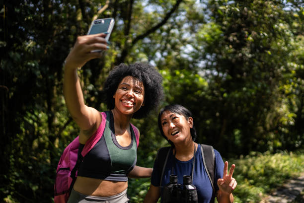 istock Friends taking selfies on the mobile phone in the forest 1367398864