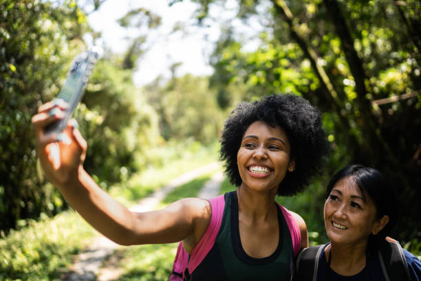 istock Friends taking selfies on the mobile phone in the forest 1367398873