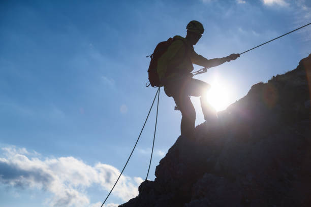 istock Silhouette of a mountain climber on a rock 1367399720