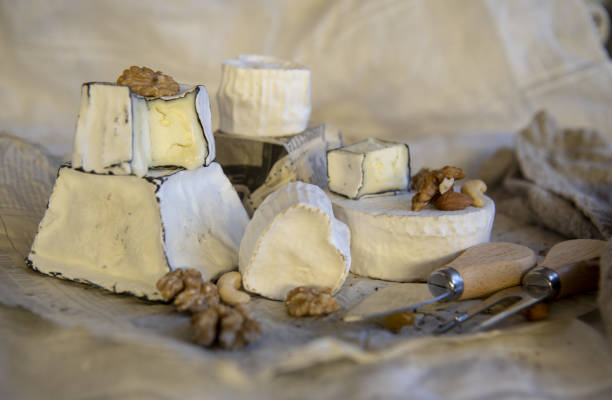 istock Various types of cheese with white mold on packaging paper. 1367399968