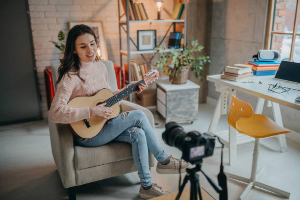 istock Female vlogger recording music related broadcast at home 1367400024