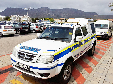 Cape Town, South Africa - January 28, 2022: A van emblazoned with the logo and colors of the South African Police Service parked in the emergency zone outside a shopping mall in the southern suburbs of Cape Town.