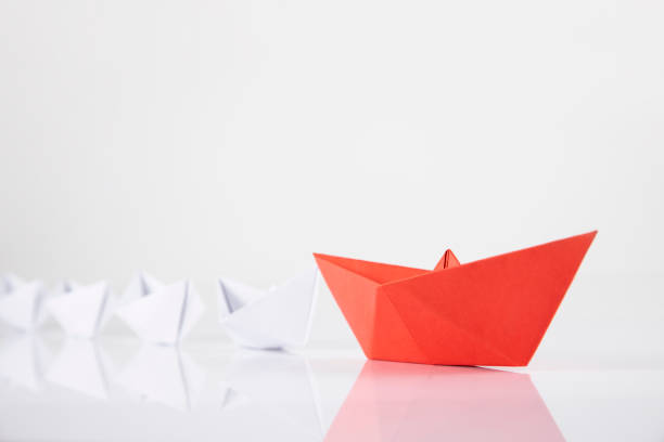 Red Paper Boat Leading Other Boats