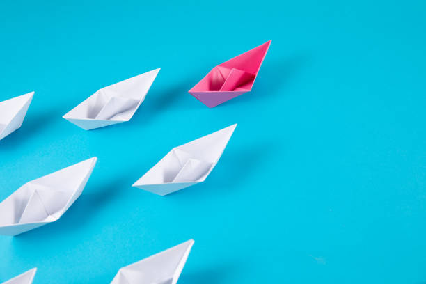 istock Red Paper Boat Leading Other Boats 1367401055