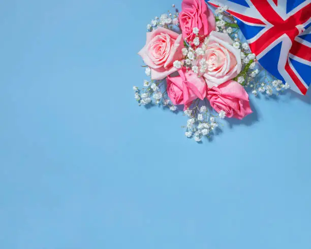 Photo of Creative british style background with flowers and united kingdom uk flag