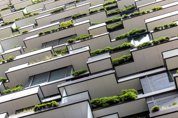 istock Closeup low angle view of apartment building with vertical gardens, background with copy space 1367401114