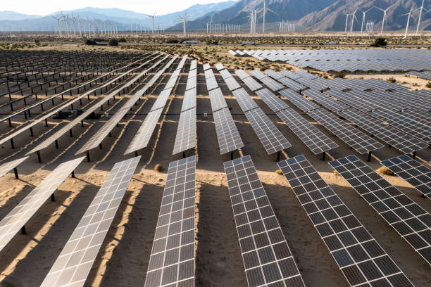 istock Aerial View over Solar Panels and Windmills 1367402339