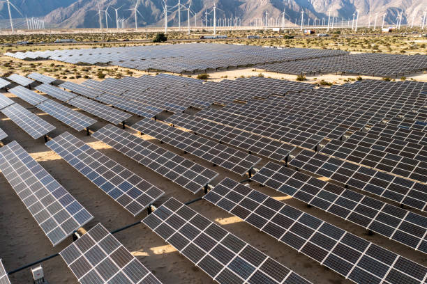 istock Aerial View over Solar Panels and Windmills 1367402360