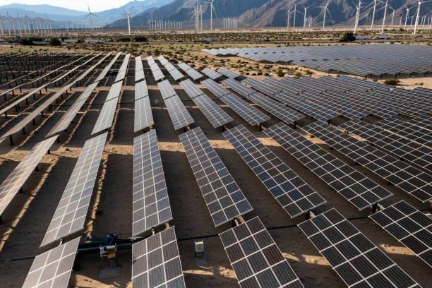 istock Aerial View over Solar Panels and Windmills 1367402373