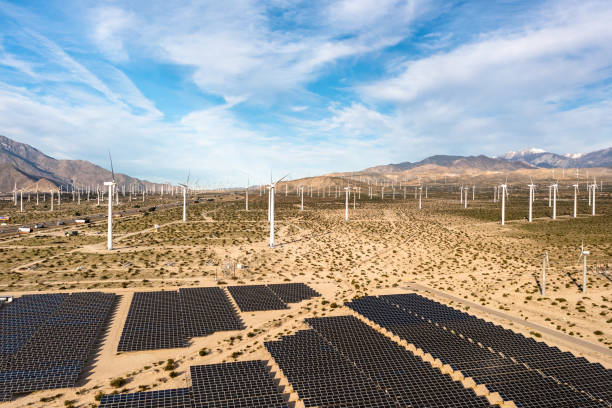 istock Aerial View over Solar Panels and Windmills 1367402398
