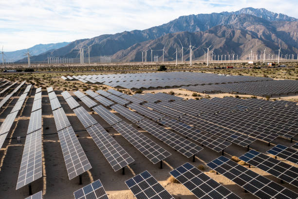 istock Aerial View over Solar Panels and Windmills 1367402542