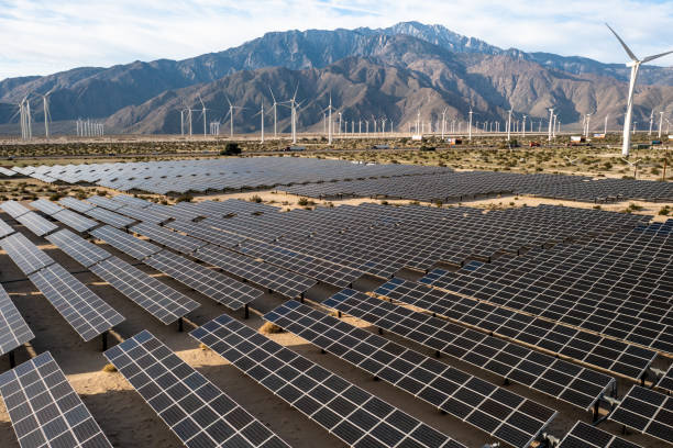 istock Aerial View over Solar Panels and Windmills 1367402548