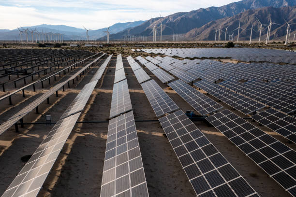 istock Aerial View over Solar Panels and Windmills 1367402574