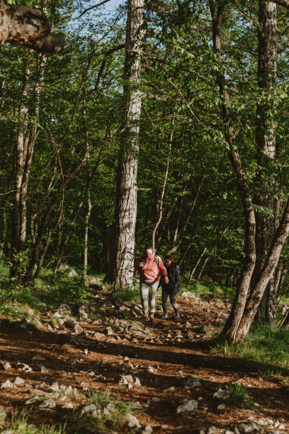 istock Two Female Friends Walking In The Forest 1367402596