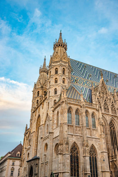 Famous iconic Stephan Cathedral at sunset colors and blue sky in historical touristic downtown of Vienna, Austria. stock photo