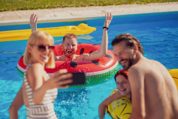 istock Friends taking a selfie at the swimming pool 1367404071