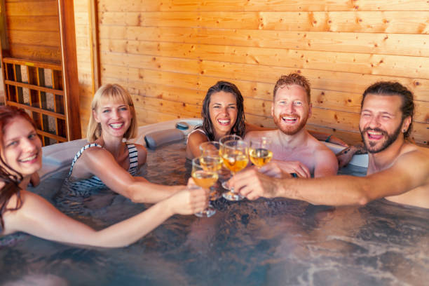 istock Friends making a toast in hot tub while on vacation 1367404129