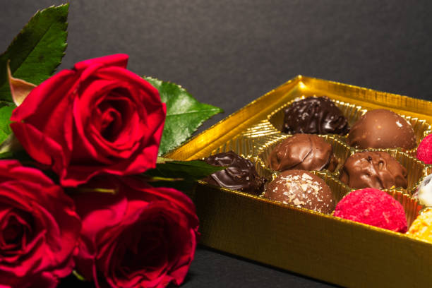 Pink roses and round chocolate in a box