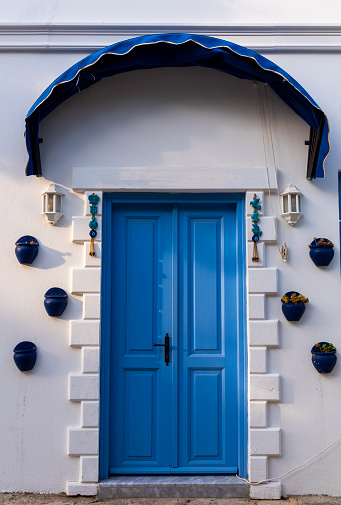 Santorini, Greece- September 20, 2017: Typical whitewashed facade with blue elements in Santorini, Greece.