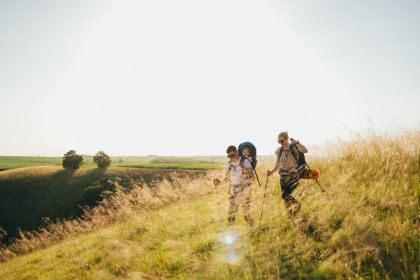 istock Happy Family With One Child Hiking Over Grass Fields 1367408469