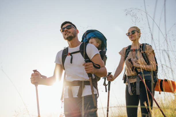 istock Happy Family With One Child Hiking Over Grass Fields 1367408492