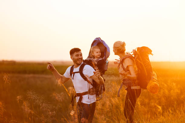 istock A Day in Nature: Young Couple Walking With Their Daughter in a Backpack Carrier 1367408556