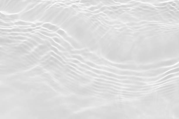 istock Water texture with sun reflections on the water overlay effect for photo or mockup. Organic light gray drop shadow caustic effect with wave refraction of light. Banner with empty space 1367413406