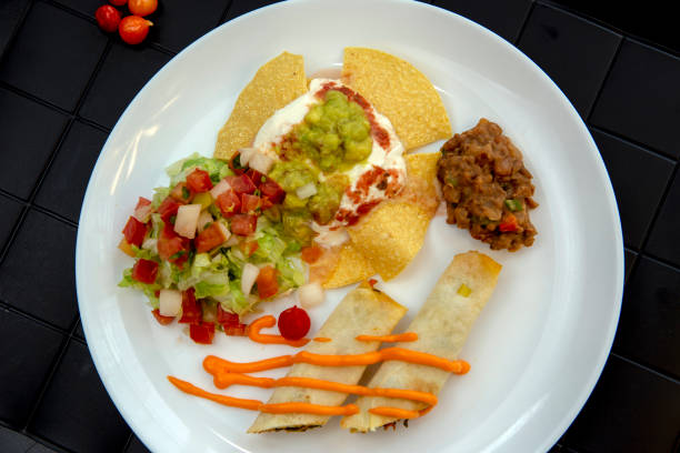 dish of typical mexican food, on a black towel - guacamole food bar vegan food imagens e fotografias de stock