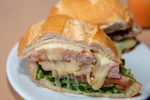 Sausage sandwich with tomato, melted cheese and lettuce, typical of the city of Braganca, in the State of Sao Paulo, Brazil