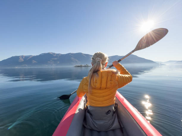 istock Woman canoeing on a lake 1367420635