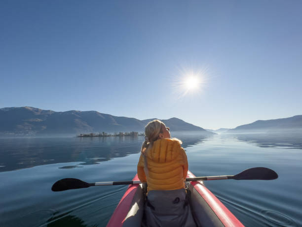 istock Woman canoeing on a lake 1367420656