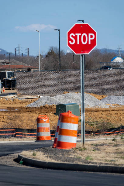 istock Stop Sign and Traffic Barrels At New Road Construction 1367421612