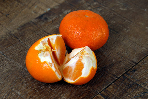 istock Mandarin orange on rustic wooden table 1367427999