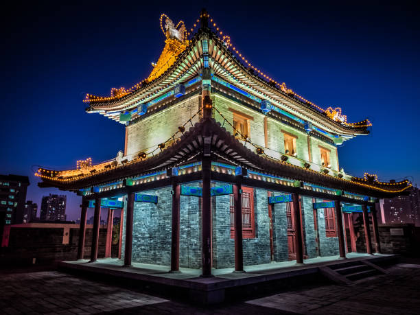 Corner tower lit up at night on the city wall, Xian, China stock photo