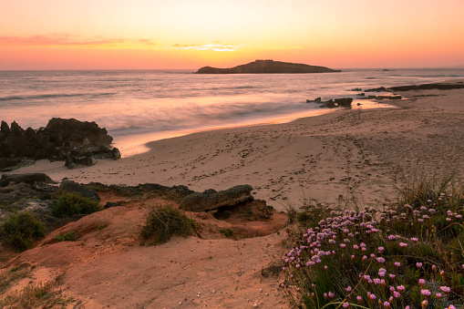 Playa de la isla de Pessegueiro en Porto Covo durante la puesta de sol photo