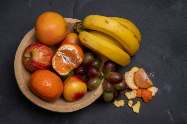 istock Trough with varied fruits on black background 1367431594