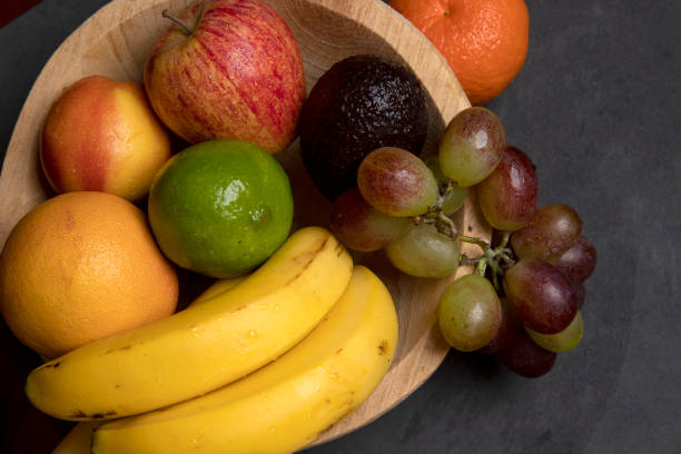 istock Trough with varied fruits on black background 1367431596