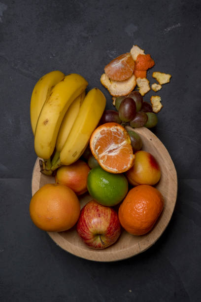 istock Trough with varied fruits on black background 1367431599