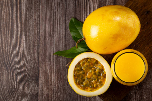 istock Glass with passion fruit juice and sliced passion fruit on the table. 1367432866